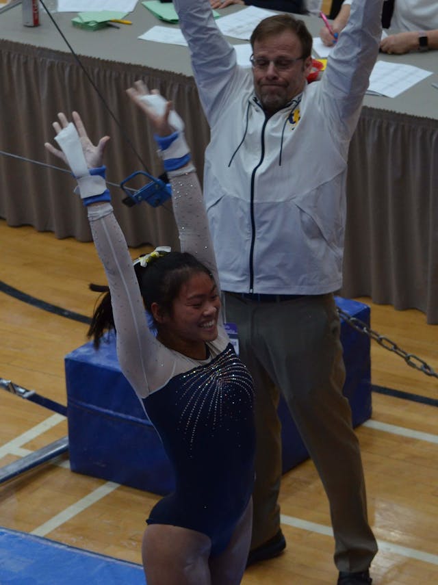 Coach and athlete celebrating after a routine